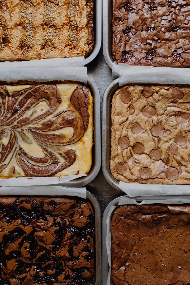 Six different types of brownies arranged in a 2x3 grid, photographed from directly above.