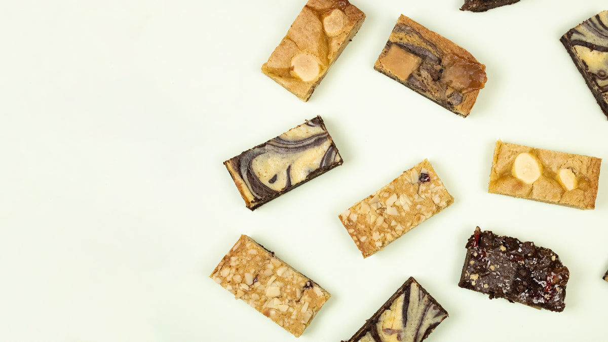 An assortment of chocolate brownies arranged on a clean white background
