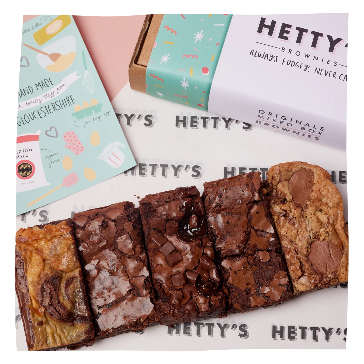 A boxed assortment of chocolate brownies from Hetty's is shown with several brownie slices arranged in front. 