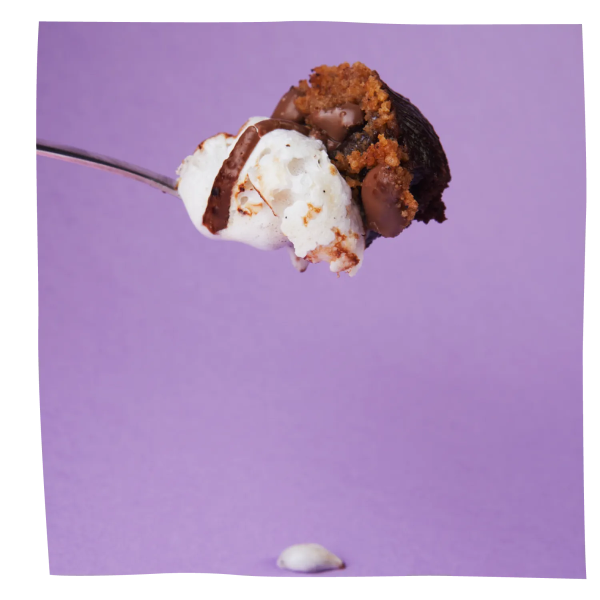 A close-up of a spoonful of dessert featuring a s'more brownie pudding