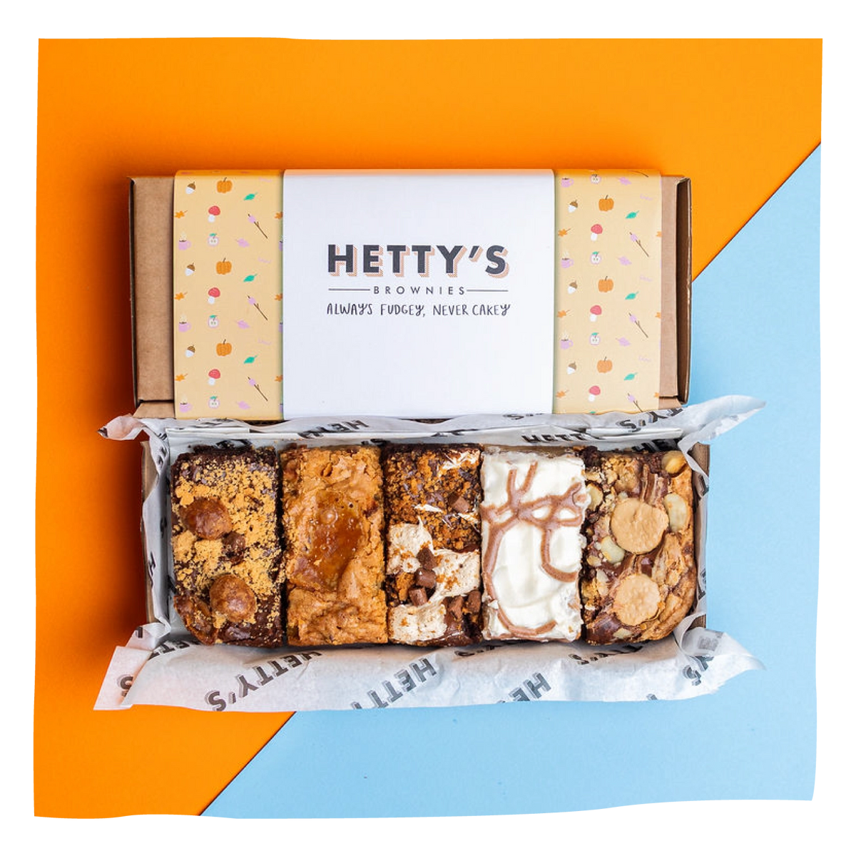 A boxed assortment of six gourmet brownies from Hetty's Brownies, displayed in an open box.