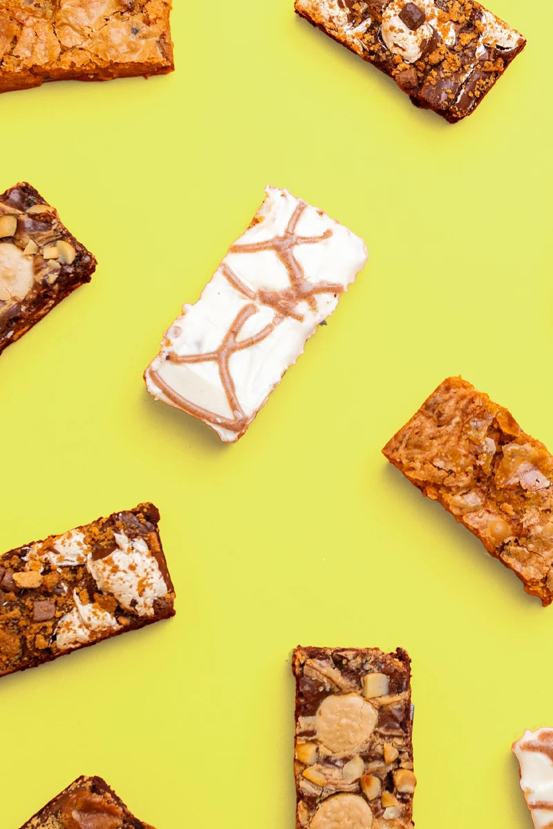 Brownie slices laying in yellow background